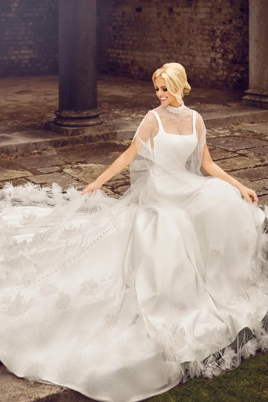 Phoenix Gowns pearl high-neck wedding dress with cape and feathered train - customisable designer bridal gowns at Wife To Be, Cheshire